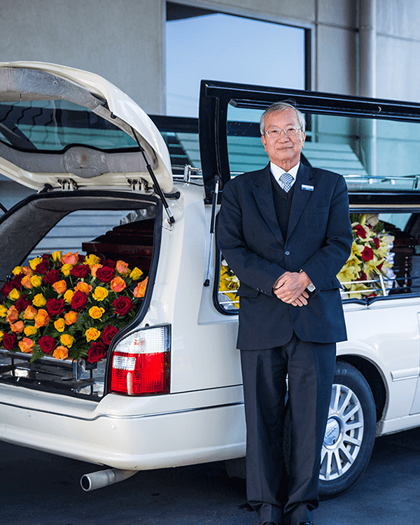 Close-up of two elderly people holding hands, showing gentle support and connection.
