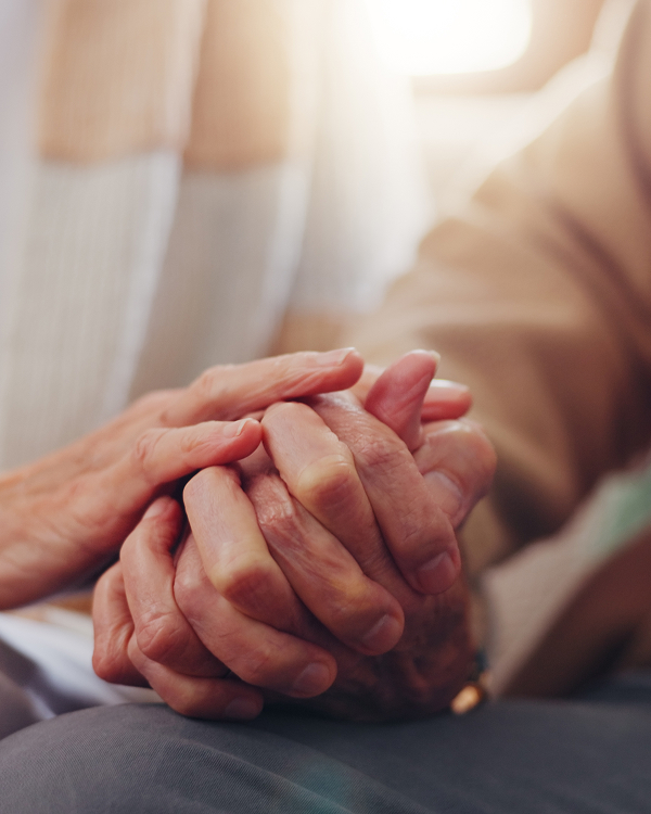 An image of two older people holding hands. The hands are zoomed into.