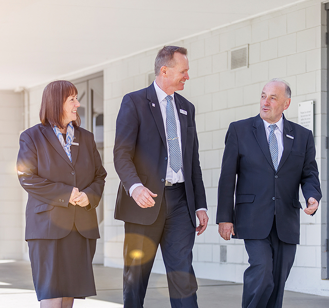 Le Pine funeral directors walking alongside each other
