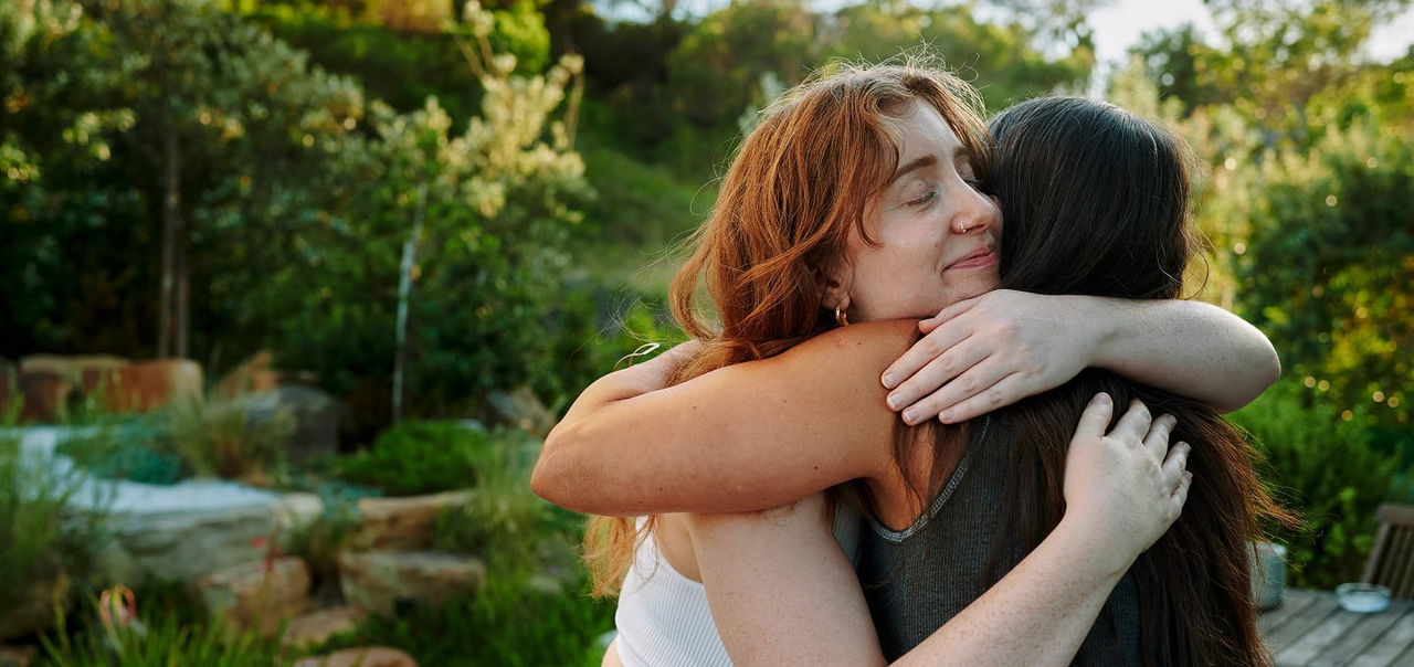 Two women hugging each other